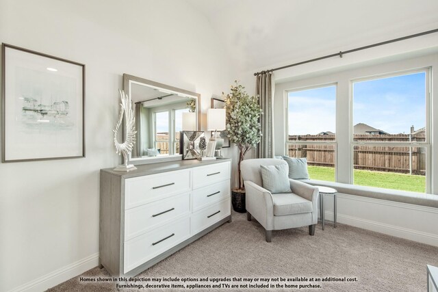 living area with light carpet, baseboards, and vaulted ceiling