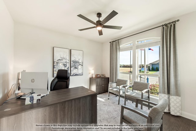 office featuring ceiling fan, baseboards, and wood finished floors