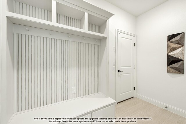 mudroom with baseboards and light wood-style flooring