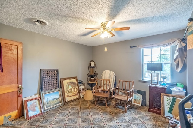 350 County Road 606 Unit B, Tuscola, TX 79562 - living area with a ceiling fan, a textured ceiling, and tile patterned floors