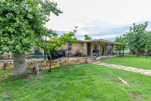 350 County Road 606 Unit B, Tuscola, TX 79562 - back of property with stone siding, a patio area, and a lawn