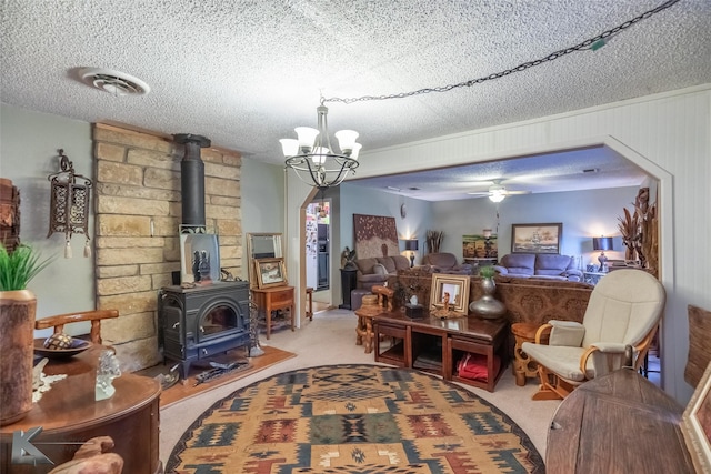 350 County Road 606 Unit B, Tuscola, TX 79562 - carpeted living room with a wood stove, a textured ceiling, ceiling fan, and a chandelier