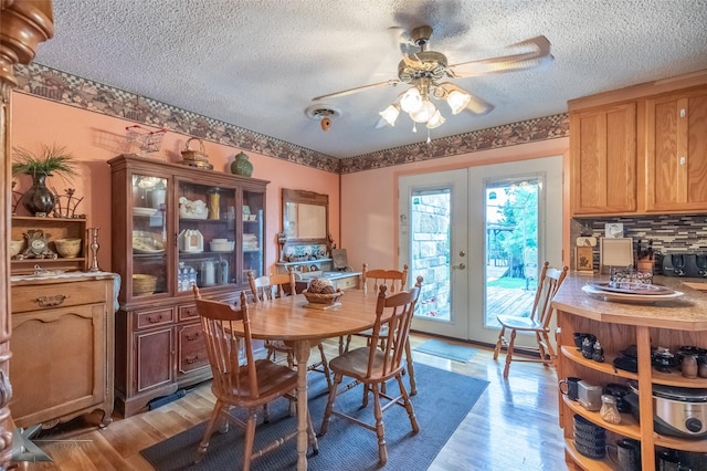 350 County Road 606 Unit B, Tuscola, TX 79562 - dining space with french doors, a ceiling fan, light wood finished floors, and a textured ceiling