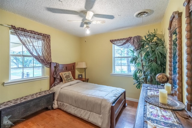 350 County Road 606 Unit B, Tuscola, TX 79562 - bedroom with a textured ceiling, wood finished floors, and ceiling fan