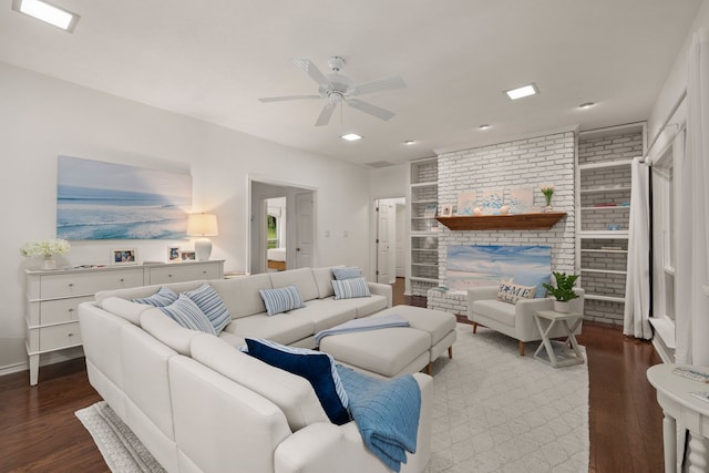 living room featuring wood finished floors, a ceiling fan, recessed lighting, and brick wall