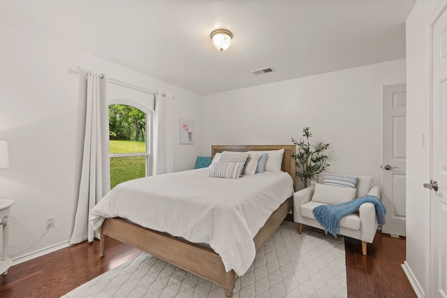 bedroom featuring wood finished floors and baseboards