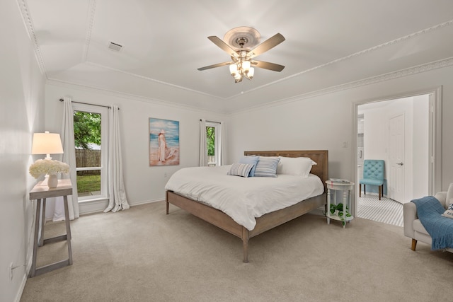 bedroom with a raised ceiling, light carpet, baseboards, ceiling fan, and crown molding