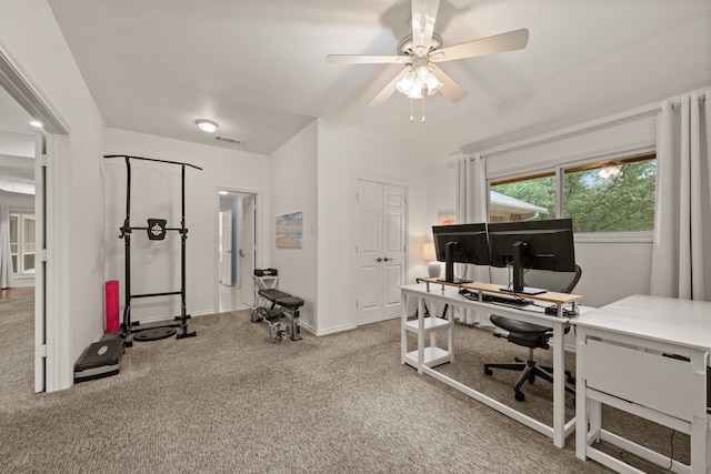 office space featuring ceiling fan, carpet floors, baseboards, and vaulted ceiling