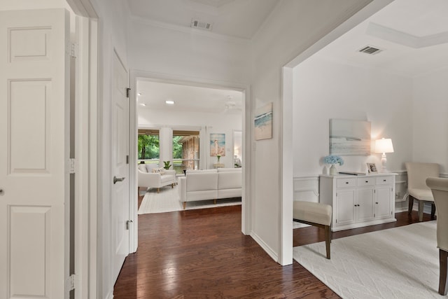 hall with dark wood-style floors and crown molding