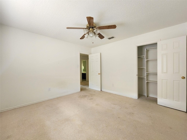 full bath with a shower stall, tile patterned floors, vanity, a textured ceiling, and toilet