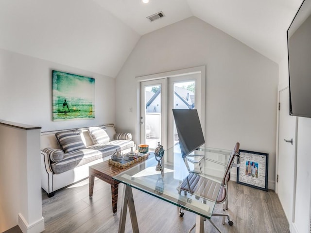 living area featuring wood finished floors and lofted ceiling