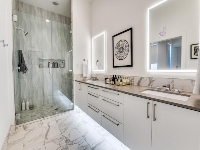 full bathroom with marble look tile flooring, a stall shower, and double vanity