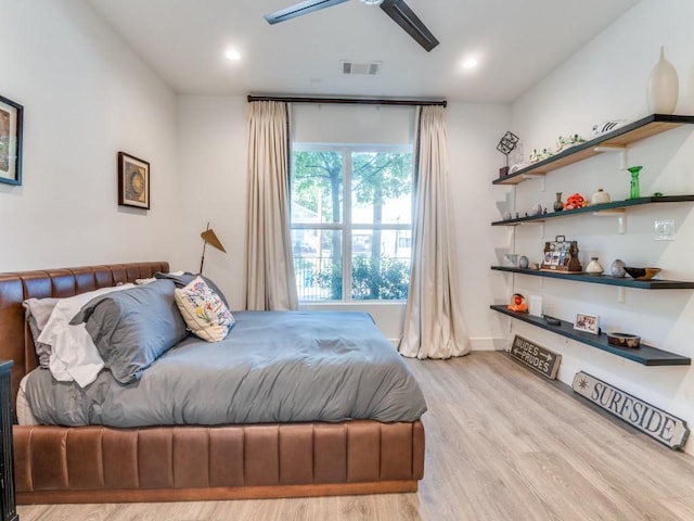 bedroom with wood finished floors, recessed lighting, and baseboards