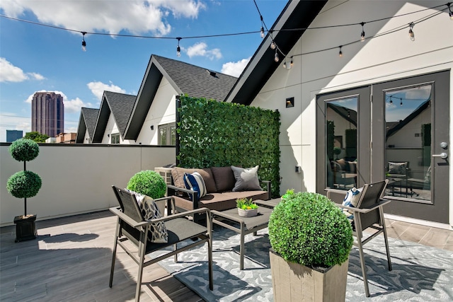 view of patio featuring outdoor lounge area, french doors, and a deck