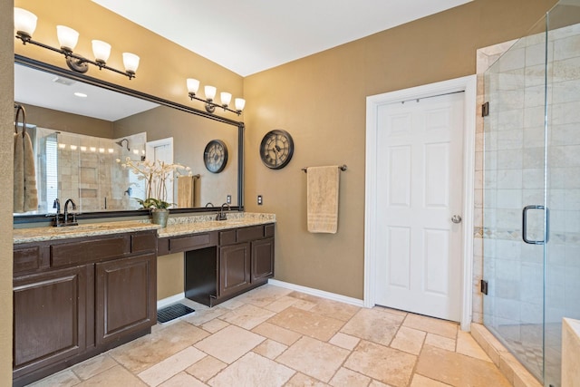 2499 Streamside Ct, Frisco, TX 75036 - full bath with a stall shower, double vanity, baseboards, a chandelier, and stone tile floors