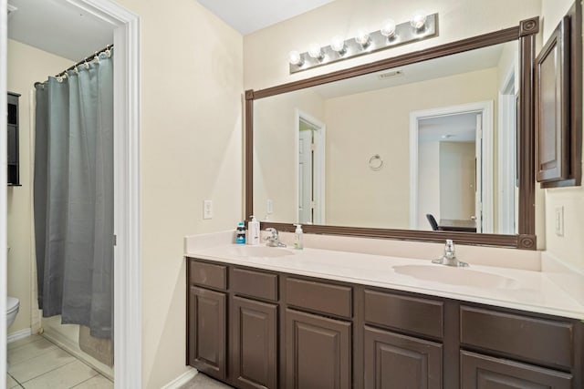 2499 Streamside Ct, Frisco, TX 75036 - bathroom with double vanity, tile patterned floors, toilet, and a shower with shower curtain