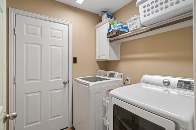 2499 Streamside Ct, Frisco, TX 75036 - clothes washing area featuring separate washer and dryer and cabinet space