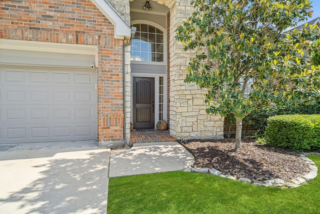 2499 Streamside Ct, Frisco, TX 75036 - property entrance with a garage, concrete driveway, and brick siding
