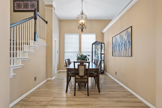 2499 Streamside Ct, Frisco, TX 75036 - dining area with a chandelier, light wood finished floors, and baseboards