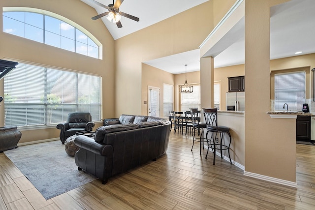 2499 Streamside Ct, Frisco, TX 75036 - living room with ceiling fan, baseboards, healthy amount of natural light, and high vaulted ceiling