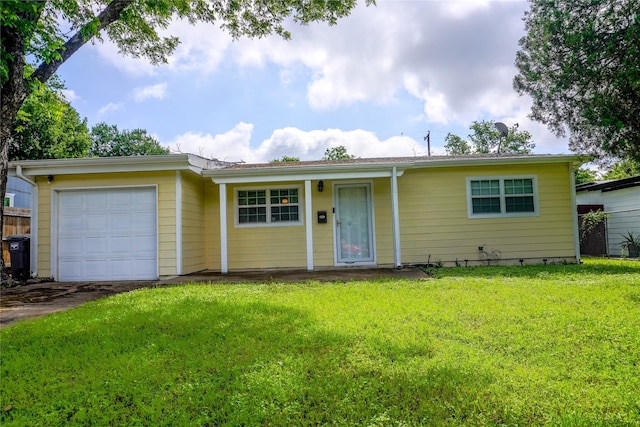 ranch-style home with a garage, a front yard, and driveway