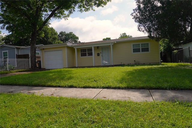 ranch-style house featuring an attached garage and driveway
