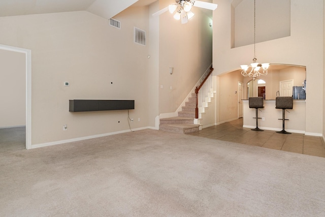 3644 Vienna St, Irving, TX 75038 - unfurnished living room with arched walkways, carpet floors, ceiling fan, a chandelier, and high vaulted ceiling
