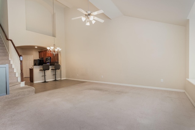 3644 Vienna St, Irving, TX 75038 - unfurnished living room with carpet floors, a chandelier, stairway, a ceiling fan, and arched walkways