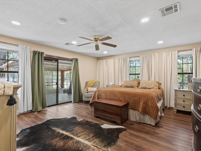 138 Selma Rd, Bowie, TX 76230 - bedroom featuring access to exterior, multiple windows, wood finished floors, a textured ceiling, and recessed lighting