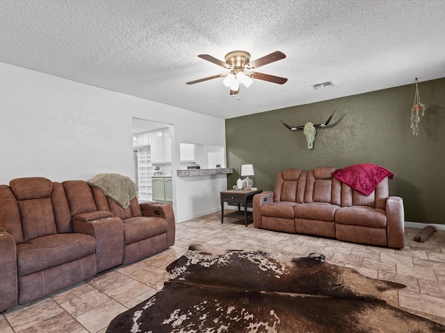 138 Selma Rd, Bowie, TX 76230 - living room with ceiling fan and a textured ceiling