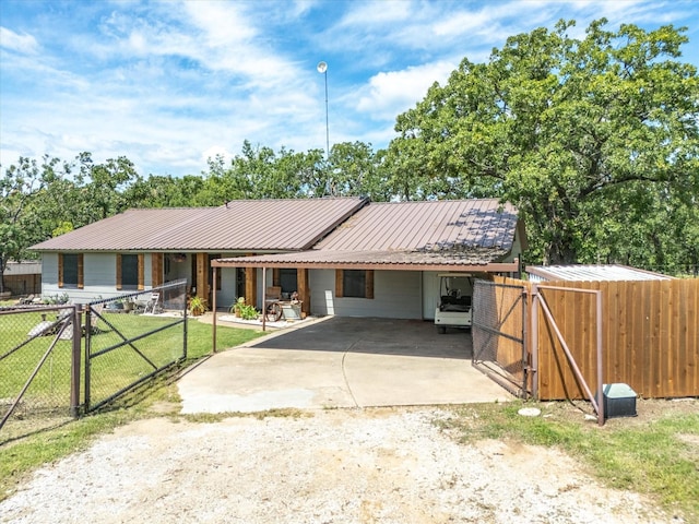 138 Selma Rd, Bowie, TX 76230 - view of front of house featuring concrete driveway, a gate, a carport, and metal roof