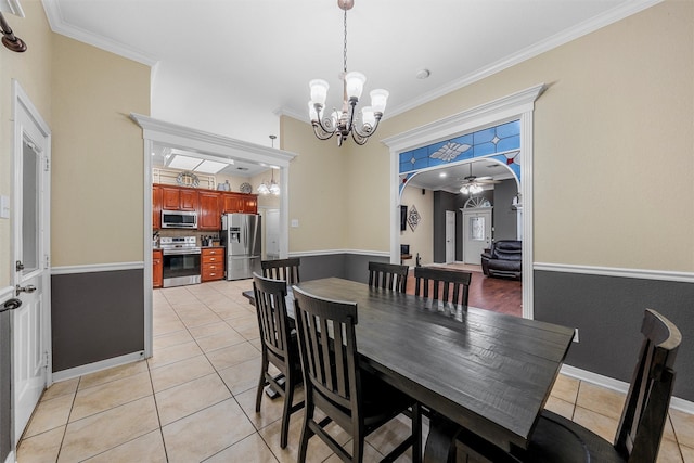 10612 Calaveras Dr, Waco, TX 76708 - dining room featuring a chandelier, light tile patterned floors, crown molding, ceiling fan, and arched walkways