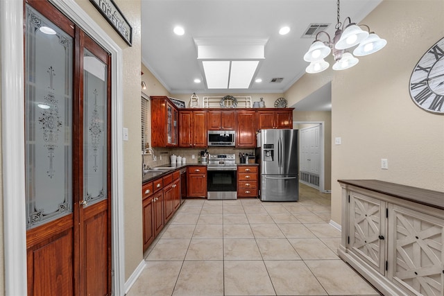 10612 Calaveras Dr, Waco, TX 76708 - kitchen with stainless steel appliances, a sink, dark countertops, backsplash, and a chandelier