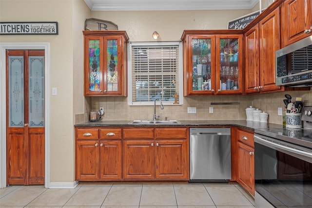 10612 Calaveras Dr, Waco, TX 76708 - kitchen with appliances with stainless steel finishes, a sink, decorative backsplash, glass insert cabinets, and ornamental molding