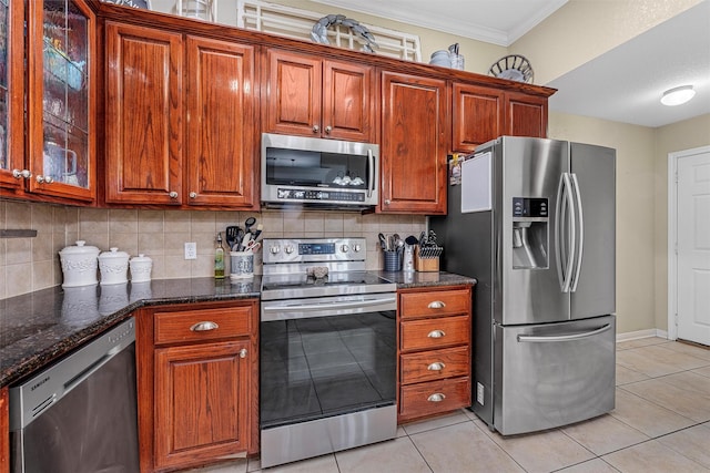 10612 Calaveras Dr, Waco, TX 76708 - kitchen with appliances with stainless steel finishes, crown molding, tasteful backsplash, light tile patterned floors, and glass insert cabinets