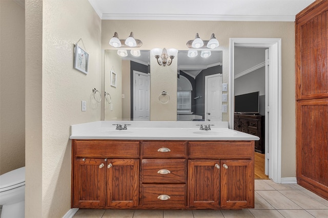 10612 Calaveras Dr, Waco, TX 76708 - bathroom featuring ornamental molding, double vanity, tile patterned floors, baseboards, and toilet