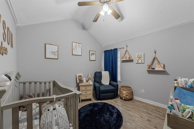 10612 Calaveras Dr, Waco, TX 76708 - bedroom with a nursery area, wood finished floors, lofted ceiling, a ceiling fan, and baseboards