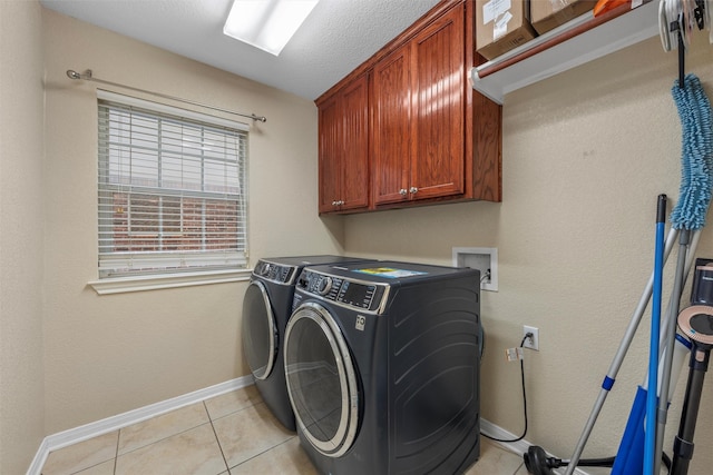 10612 Calaveras Dr, Waco, TX 76708 - laundry area featuring cabinet space, independent washer and dryer, light tile patterned floors, and baseboards