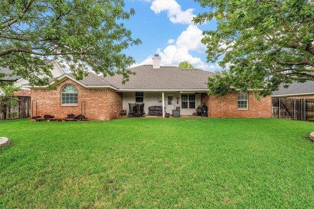 10612 Calaveras Dr, Waco, TX 76708 - rear view of house featuring a chimney, brick siding, and a patio
