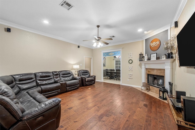 10612 Calaveras Dr, Waco, TX 76708 - living area with wood finished floors, ceiling fan, ornamental molding, a tiled fireplace, and recessed lighting