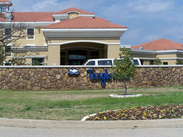 2164 Tanglewood Blvd Unit B202, Pottsboro, TX 75076 - view of exterior entry with a tile roof and stucco siding