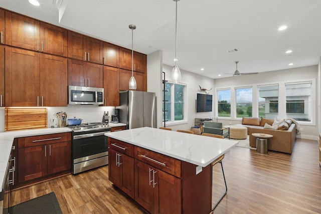 461 Rayner Ave, Fort Worth, TX 76111 - kitchen with stainless steel appliances, wood finished floors, tasteful backsplash, decorative light fixtures, and ceiling fan