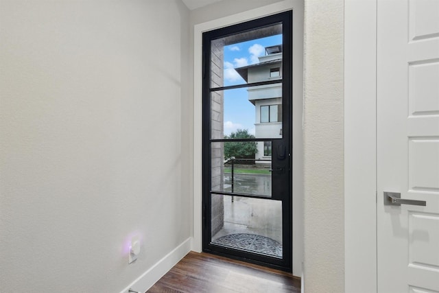 461 Rayner Ave, Fort Worth, TX 76111 - doorway to outside with baseboards, healthy amount of natural light, and dark wood-style flooring