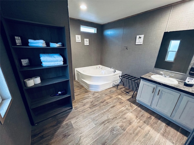 204 N Marion St, Richland Springs, TX 76871 - bathroom with vanity, wood finished floors, and a garden tub