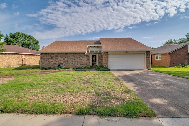 mid-century home featuring brick siding, a garage, a front lawn, concrete driveway, and roof with shingles