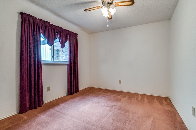 carpeted spare room featuring ceiling fan and a textured ceiling