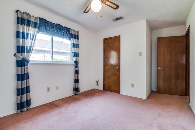 unfurnished bedroom featuring carpet floors and ceiling fan