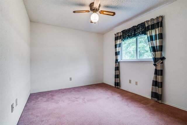 carpeted spare room with a ceiling fan and a textured ceiling