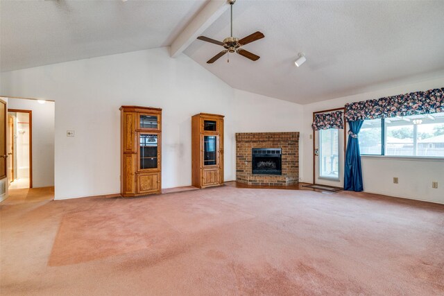 unfurnished living room featuring ceiling fan, light colored carpet, a fireplace, beamed ceiling, and high vaulted ceiling