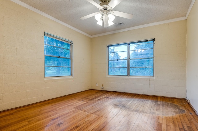 1455 N Joe Wilson Rd, Cedar Hill, TX 75104 - spare room featuring hardwood / wood-style flooring, a textured ceiling, ceiling fan, crown molding, and concrete block wall